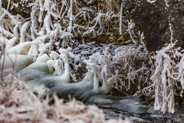 Fast river with ice and snow in late autumn