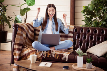 Full size photo of young excited woman happy positive smile look laptop rejoice victory fists hands...