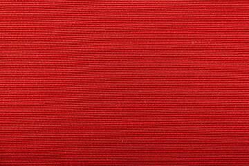 Factory fabric of red color . Close-up long and wide texture of natural red fabric. Fabric texture of natural cotton or linen textile material. Red canvas background