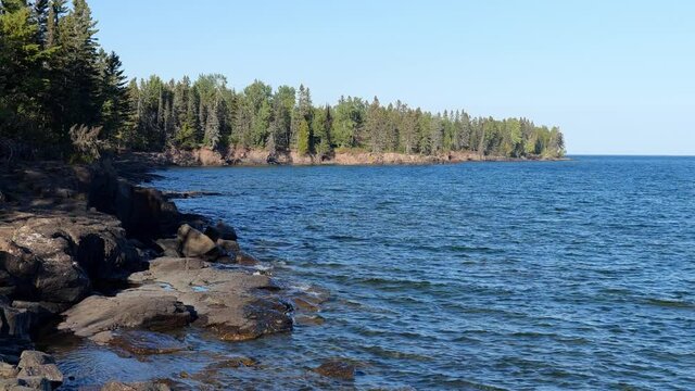 Beautiful landscape along the north shore of Lake Superior in Minnesota, from Palisade Head. An unidentifiable rock climber can also be seen high above the water on the natural sheer cliff.