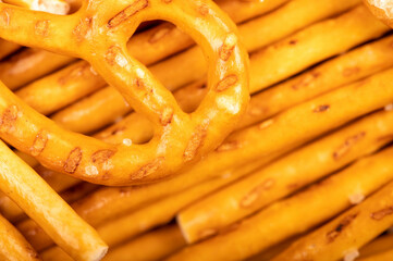 Crispy bread straws with salt, close-up, selective focus, top view.