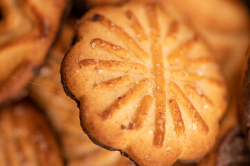 Curly cookies covered with chocolate icing, background image, close-up, selective focus.