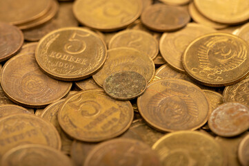 Old coins out of circulation in bulk, background image, close-up, selective focus.