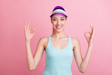 Obraz na płótnie Canvas Photo of sweet adorable young woman dressed teal singlet smiling showing okey signs isolated pink color background