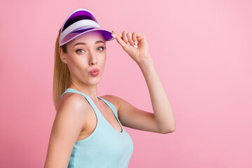Obraz na płótnie Canvas Profile photo of cute blond young lady blow kiss wear blue top visor isolated on pink color background