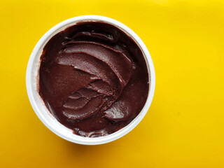 açaí in white plastic pot and yellow background with space for text