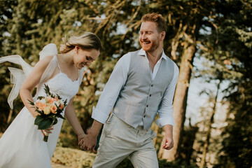 Young newlywed couple walking in the park