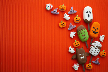 Set of ice cream and cookies with halloween character face on orange background. Halloween party...