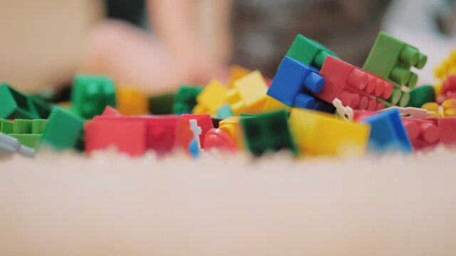 Childrens developing color constructor. Scattered across the floor. Scattered colored childrens constructor on floor.