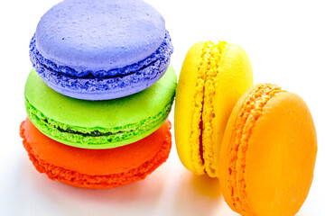 pile of colorful and tasty french macaroons on white background