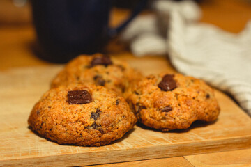 closeup of homemade vegan chocolate chip cookies on a wooden board