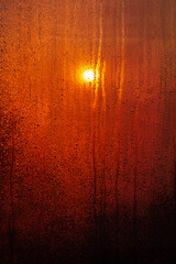 water drops on the window after rain and orange sun