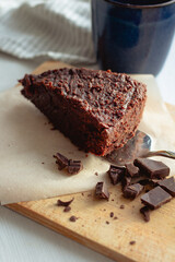 piece of homemade chocolate cake on a wooden board