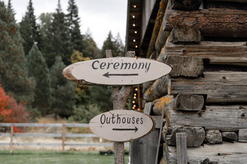 A signboard ceremony Signboard directions to the wedding Symbol sign at wedding venue  Wooden Signpost  Outhouses pointing to Wedding decor Wooden plaque with the inscription in paint wood background