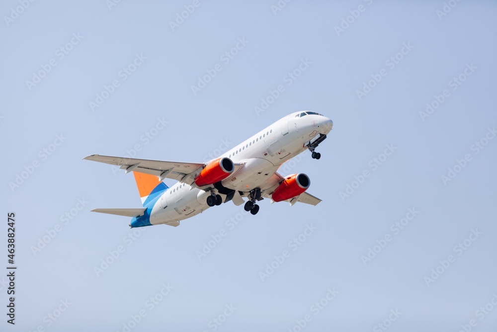 Sticker Airplane liner flying above in the beautiful sky. Travel concept.