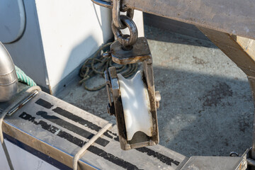 Close-up with selective focus of a pulley, on a fishing boat.