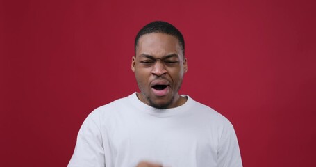 Lazy african american man yawning over maroon background - Powered by Adobe