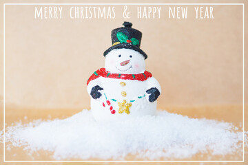 greeting card Christmas tree toy snowman on a snowdrift on a craft background with the inscription...
