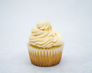 vanilla cupcake decorated with piping bag white vanilla cream 
