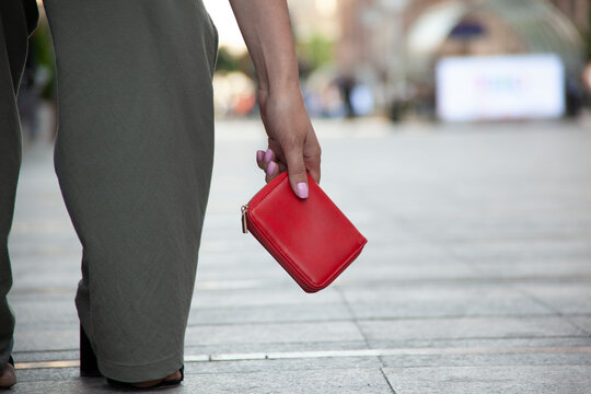 woman and a wallet on the ground in street