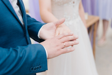 hands of bride and groom with rings close up
