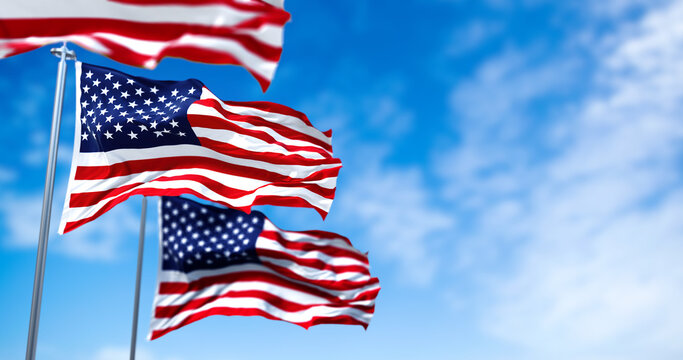 Three flags of the United States of America waving in the wind