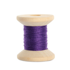 Wooden spool of purple sewing thread isolated on white