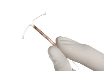 Gynecologist holding copper intrauterine contraceptive device on white background, closeup