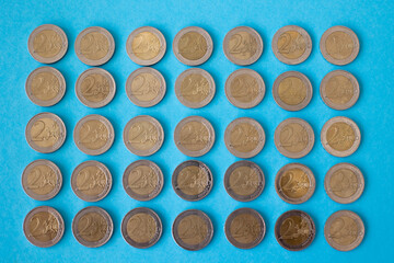 Coins on a blue background isolated Business attraction of euro money