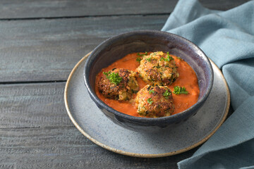 Fried vegetable balls from zucchini and potato in tomato sauce, vegan vegetarian meatball...