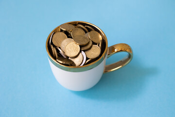 Mug with coins on a blue background