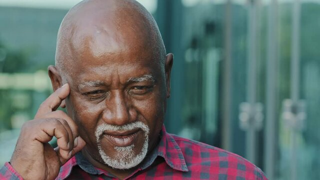 Thoughtful Mature adult African American man thinking, solve problem, worried black old male feels concerned puzzled lost in thoughts pondering making decision raised index finger up with great idea