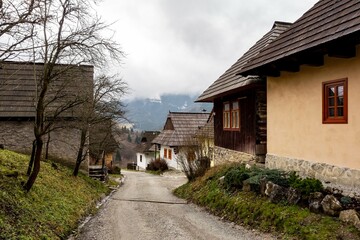 Fototapeta na wymiar The street between houses in traditional folk historic Vlkolinec open air museum near Ruzomberok city in Slovakia