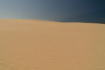Fototapeta na wymiar sand dunes in the Leba desert with blue sky