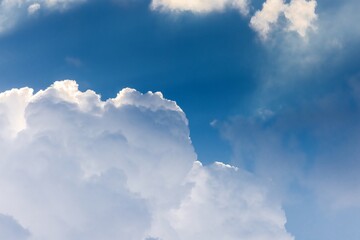 Naklejka na ściany i meble Fluffy cloud agains blue sky
