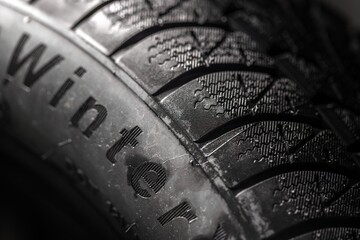 Clean car tyres spinning against dark background