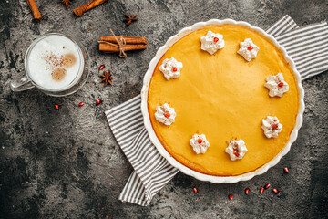 Traditional American pumpkin pie with cinnamon decorated with whipped cream and latte. banner,...