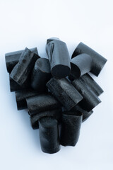 Closeup of a bunch of Finnish black licorice against a bright white background