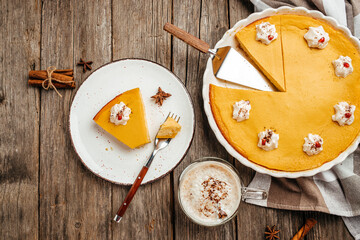 Homemade Pumpkin Pie for Thanksgiving day with latte. banner, menu, recipe place for text, top view