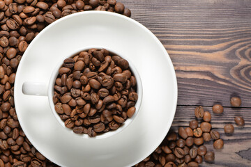 White coffee mug filled with coffee beans