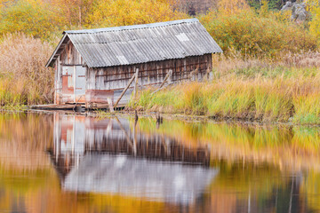 Ancient hangar for the boats by the lake water's edge.