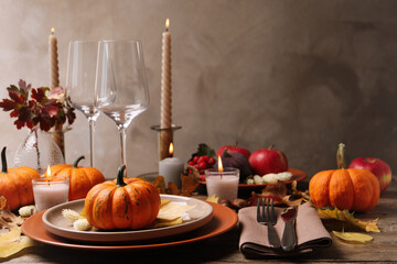 Beautiful autumn place setting and decor on wooden table, space for text