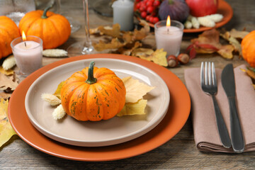 Beautiful autumn place setting and decor on wooden table