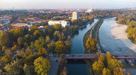 Aerial view of Isar river flowing into Munich and Thalkirchen bridge with cars in a beautiful...
