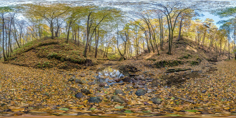 full seamless hdri 360 panorama near mountain stream in tree-covered ravine in autumn forest in...