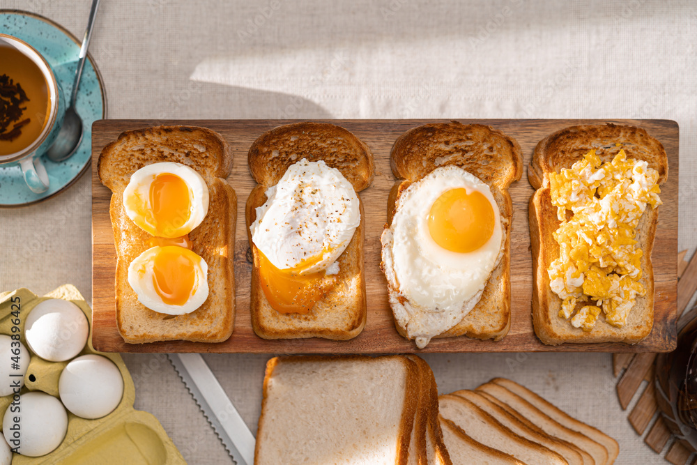 Wall mural fried toast bread with four different types of cooked chicken eggs, scrambled eggs, fried eggs, poac