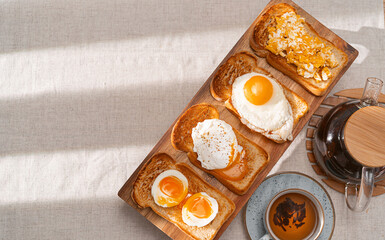 fried Toast bread with four different types of cooked chicken eggs, scrambled eggs, fried eggs, poached egg and creamed egg. Breakfast of chicken eggs. methods of making eggs for breakfast