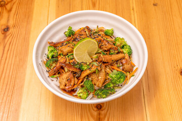 pad thai noodles, soy sauce, bean sprouts, eggs, chicken and broccoli, carrots, garlic, sugar and salt with peanuts, lime and coriander