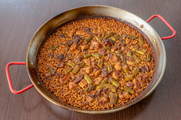 Spanish paella of boletus mushroom with wild asparagus, socarrat rice served in its paella pan