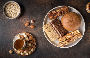 Cereal bars with ingredients in ceramic plate. Healthy granola superfood bars. top view